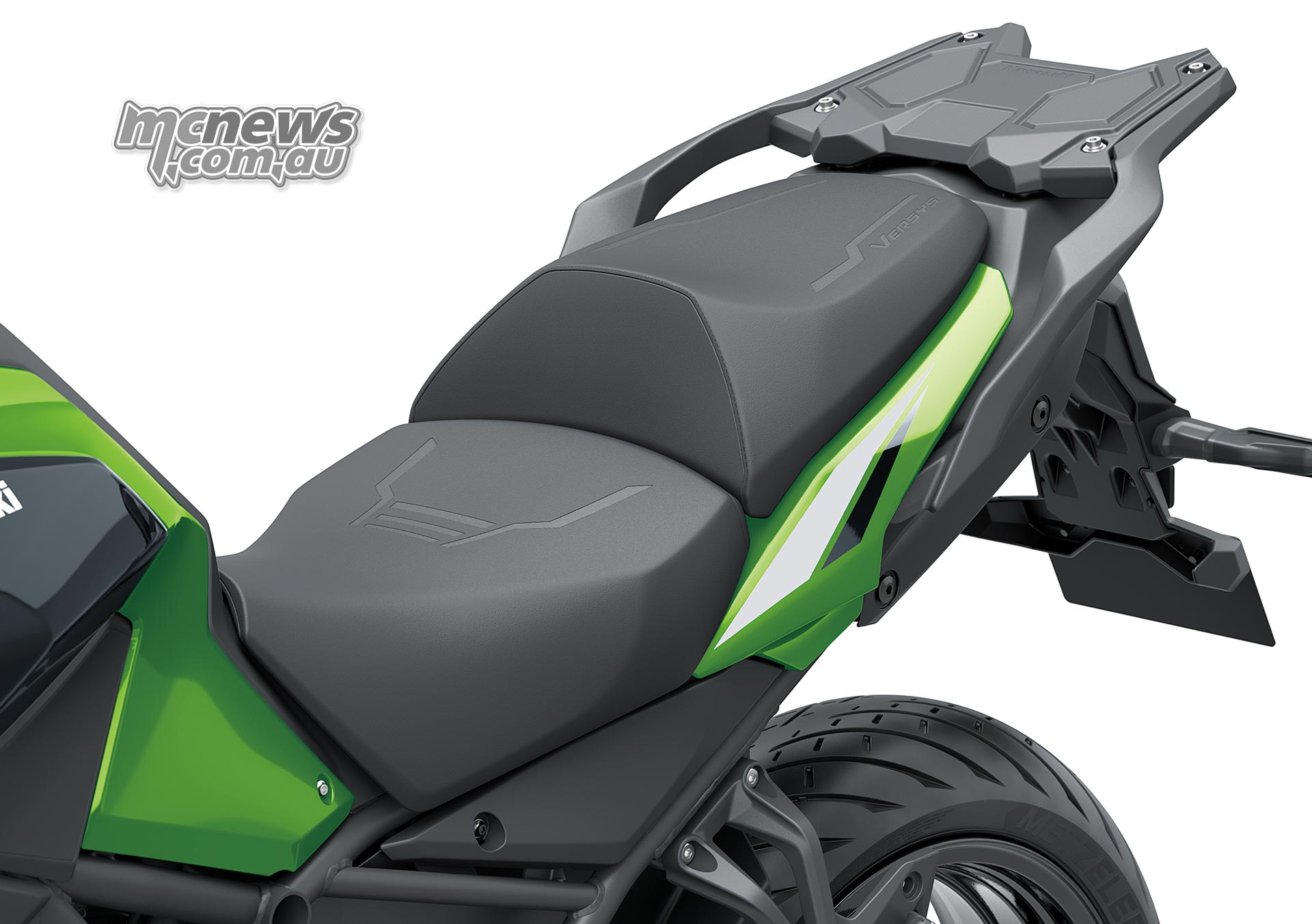 Two-piece black seat on the Kawasaki Versys 900 SE with green side panels and a rear luggage carrier