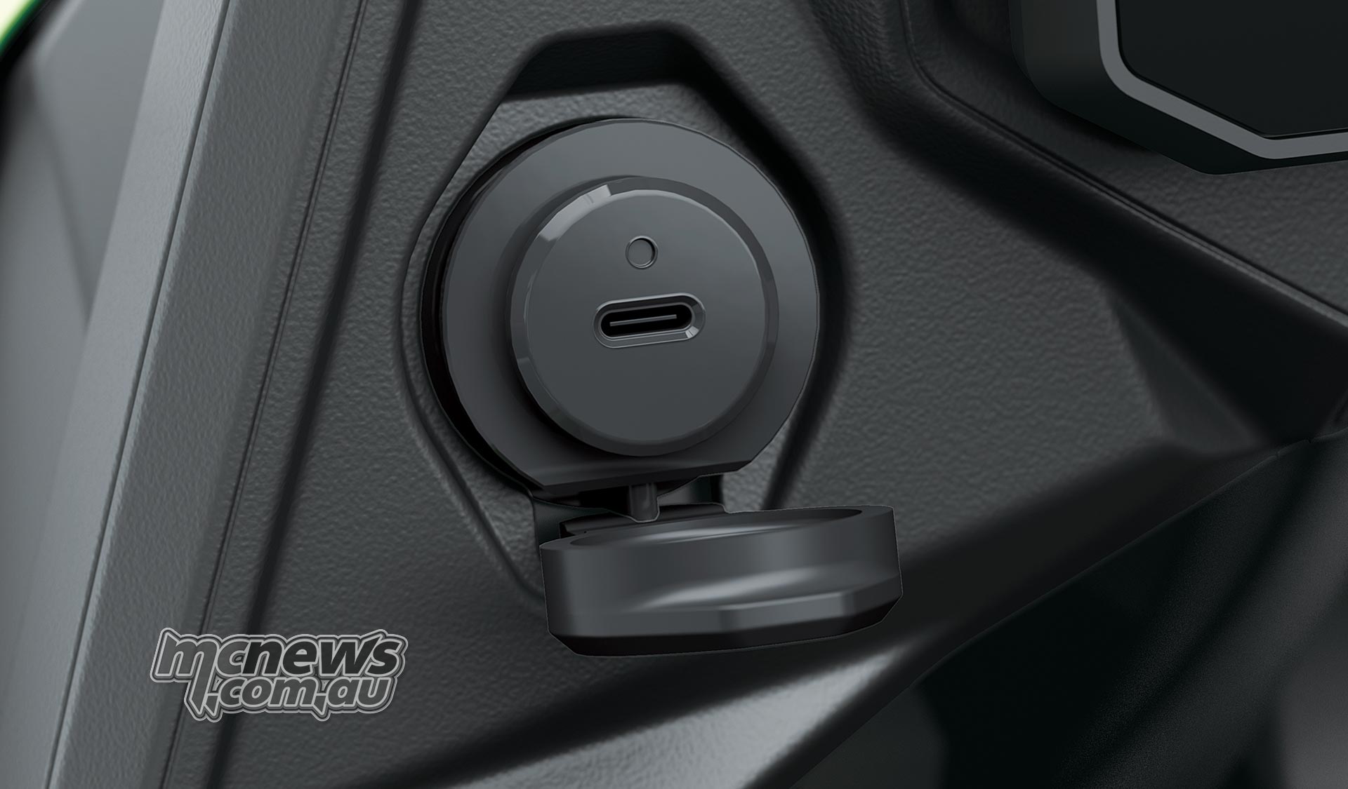 Close-up of the Kawasaki Versys 900 SE USB-C socket with its protective cover open