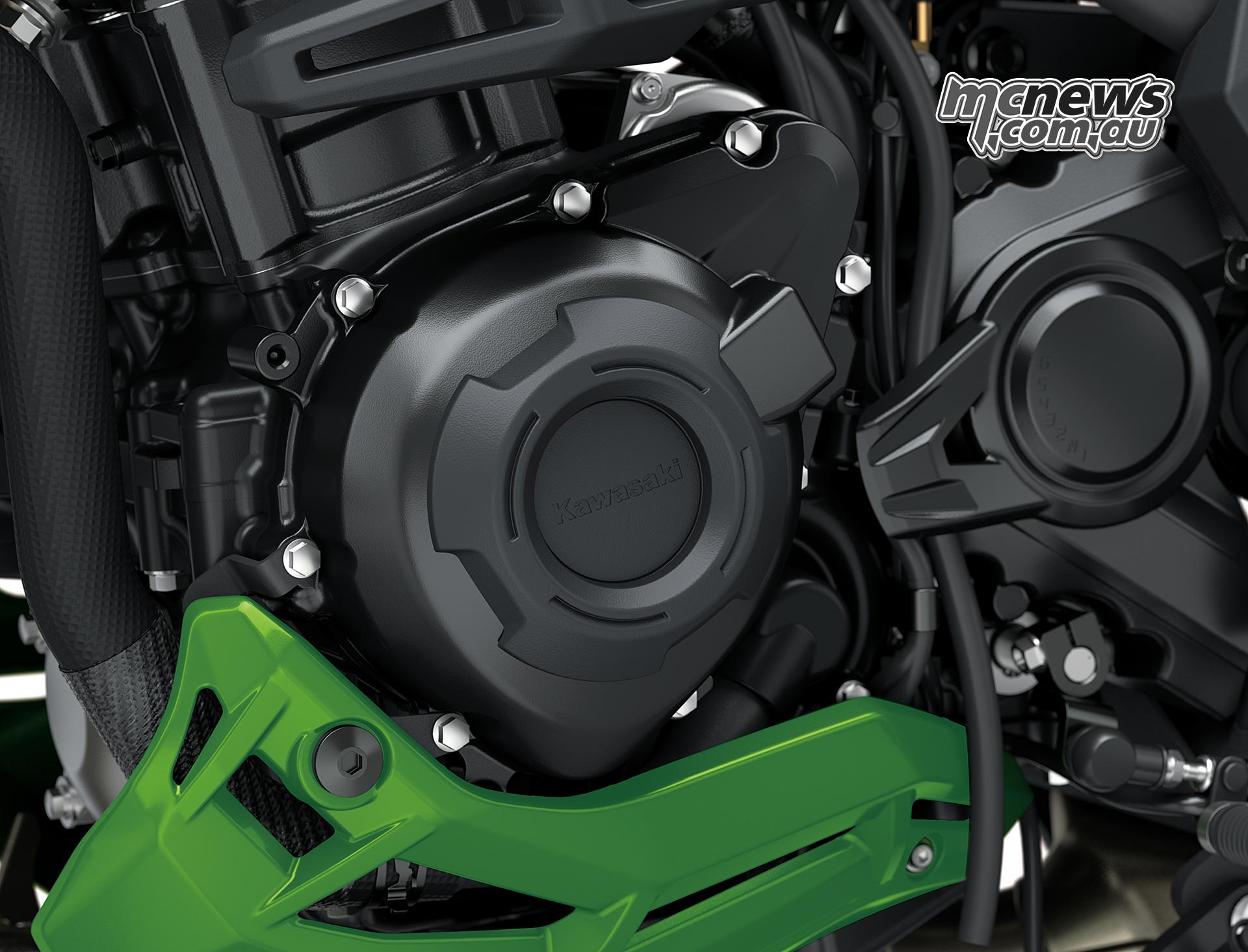 Black accessory ring around a circular Kawasaki Versys 900 SE engine cover above the green lower cowl
