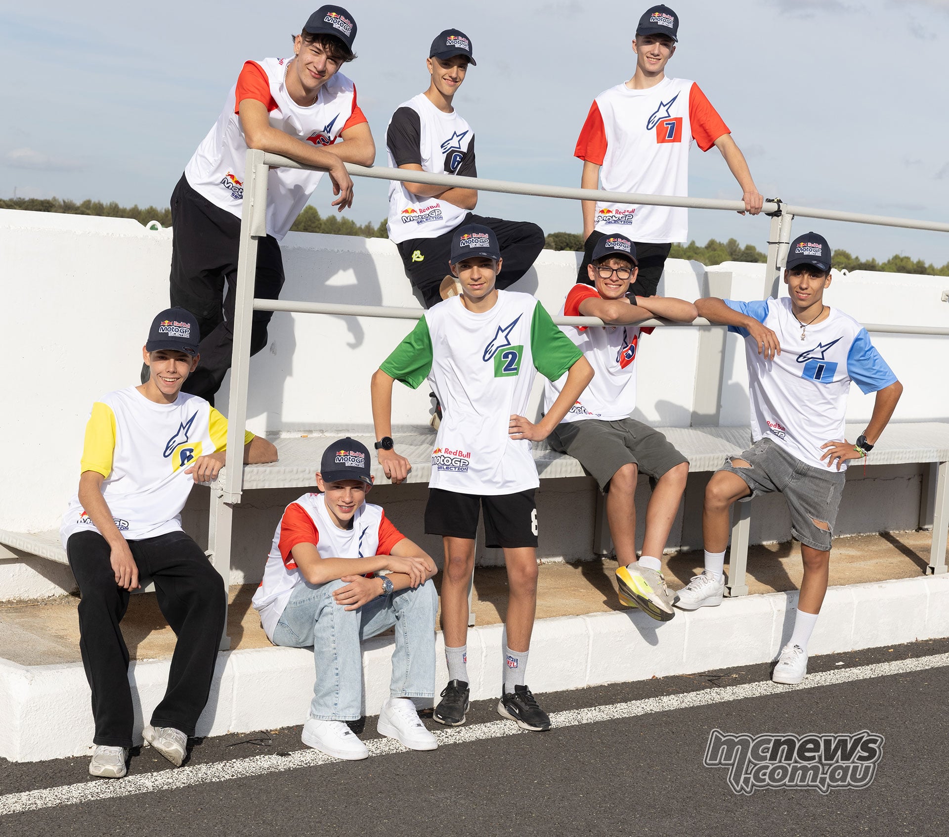 Eight successful 2027 Red Bull Rookies Cup candidates pose together on a grandstand at Guadix