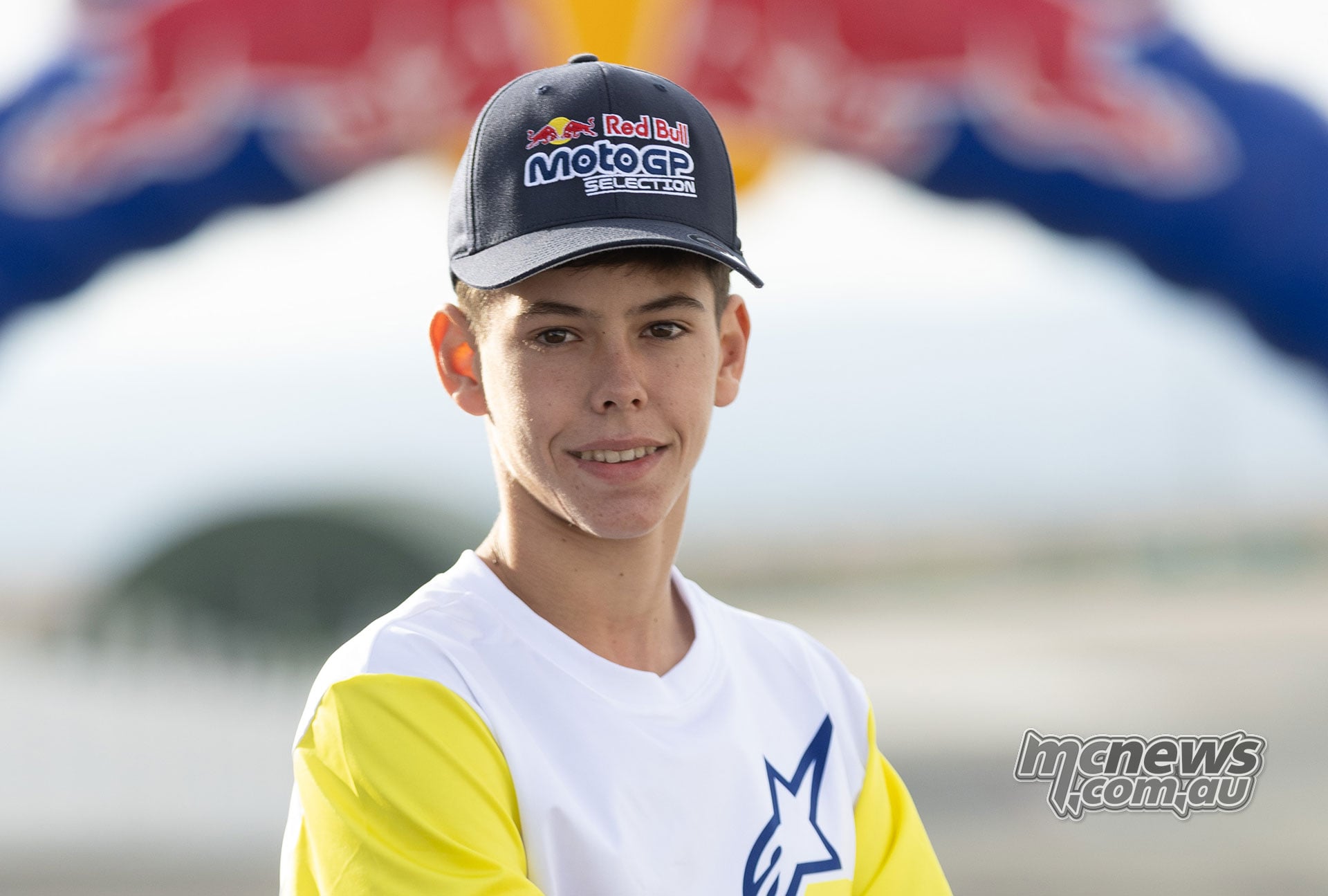 Spanish rider Victor Cubeles wearing a Red Bull MotoGP Selection cap and yellow-sleeved Alpinestars shirt