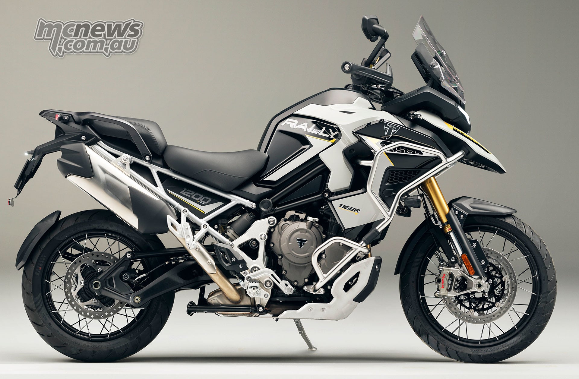 2027 Triumph Tiger 1200 Rally Explorer shown in right-side profile with wire-spoked wheels and crash protection