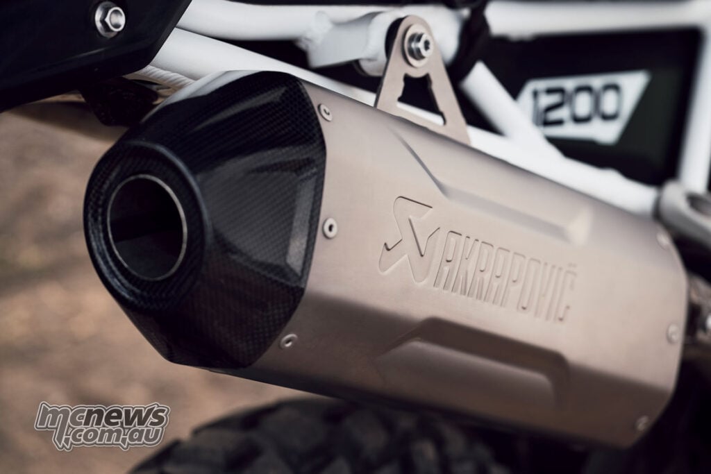 Close-up of the accessory Akrapovic exhaust silencer fitted to a 2027 Triumph Tiger 1200 Rally Pro.