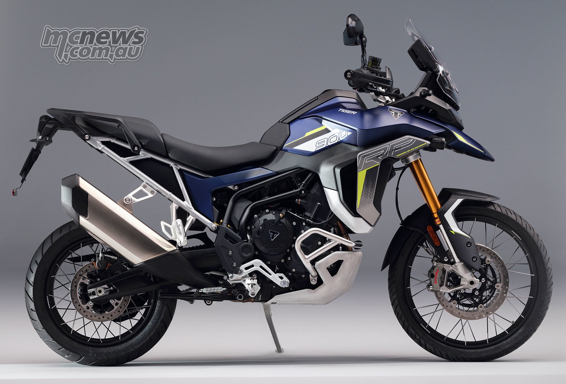 2027 Triumph Tiger 900 Rally Pro shown in right-side profile with blue bodywork and gold forks