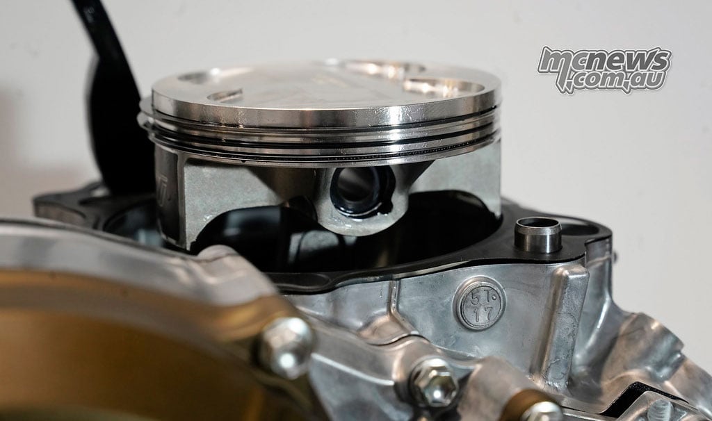 Piston and connecting rod exposed above the Yamaha crankcase with the cylinder removed.