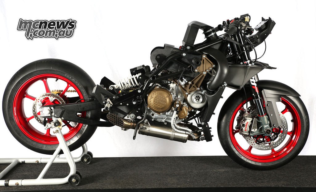 WMC Mono RR with its bodywork removed, exposing the engine and intake system between red wheels.
