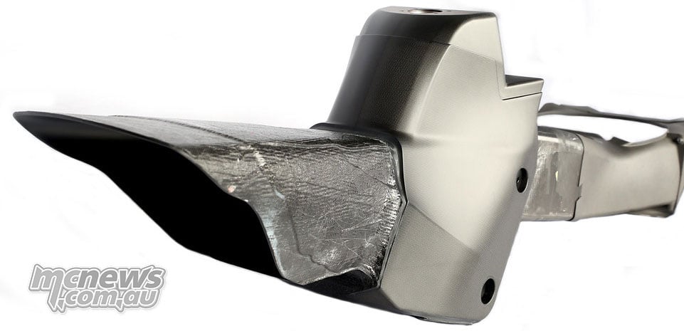 Long carbon-fibre duct assembly with a raised tank section and reflective heat shielding.