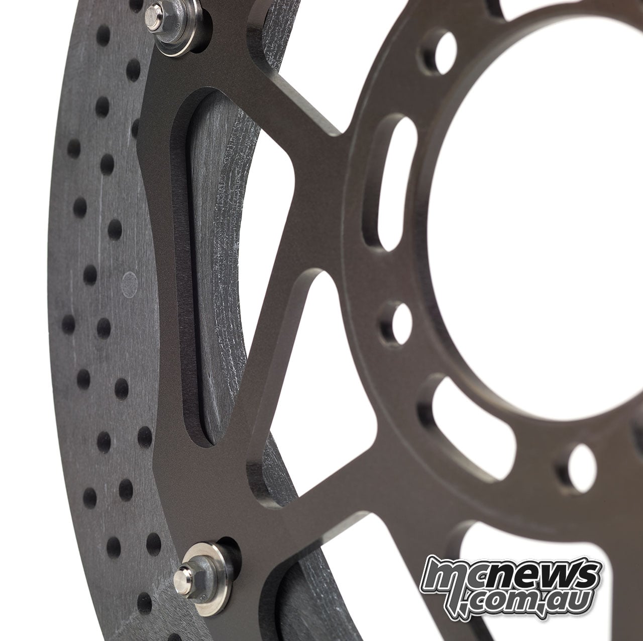 Close-up of the Hyction disc showing its drilled carbon-ceramic braking ring, aluminium carrier and attachment points.
