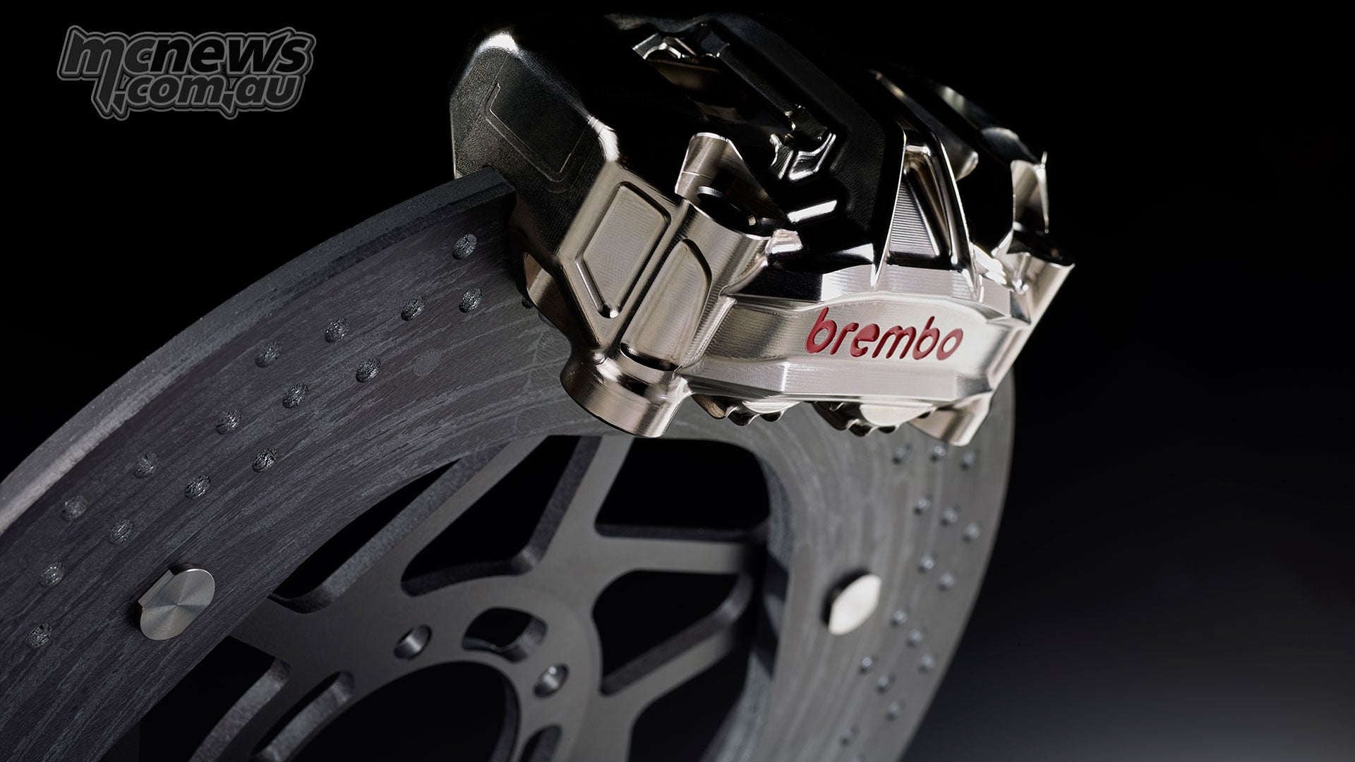 Brembo GP4-HY caliper positioned over a Hyction carbon-ceramic brake disc against a black background.