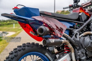 Close-up of Honda XL750 Transalp Ruth rear section with twin exhausts and knobby tyre