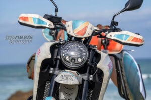 Front close-up of Honda XL750 Transalp Ocean Nomad custom with round headlight and retro handguards