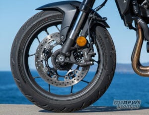 The Nissin front brakes combine progressive feel with serious power, while the fast-cycling ABS coped confidently with torn-up corner entries. Honda CB1000GT front wheel with Nissin brake caliper, brake disc, ABS ring and Michelin Road 6 GT tyre.