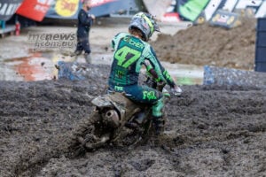 Levi Kitchen, number 47, steers his Kawasaki through deep mud with one boot extended during the second Columbus moto.