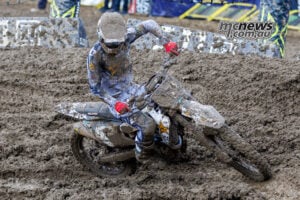 Daxton Bennick leans his mud-covered Husqvarna through a rutted corner during the closing stages of Race Two at Columbus.