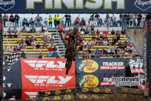 Cole Davies jumps beneath the finish gantry as the chequered flag waves for his 250SMX Race Two victory at Columbus.