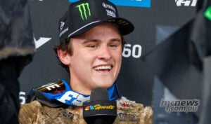Haiden Deegan smiles during his post-race interview, wearing a Yamaha cap and mud-covered race gear.
