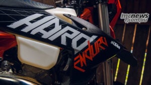 Close-up of the 2027 KTM 300 EXC HARDENDURO black, white and orange radiator-shroud graphics.