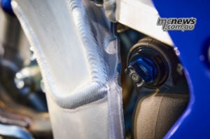 The revised KYB rear shock gains a new piston and a hand-operated low-speed compression damping adjuster for quick trailside changes without tools. Hand-adjustable low-speed compression damping control on the 2027 Yamaha WR450F KYB rear shock