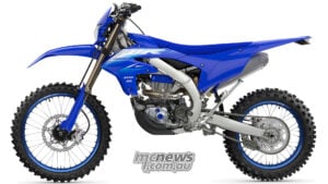 A 51-tooth rear sprocket replaces the previous 50-tooth item, shortening the final gearing to improve response and low-speed usability. Left-side studio view of the 2027 Yamaha WR450F showing chain final drive and rear sprocket