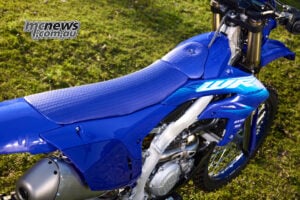 The new honeycomb-pattern seat cover is designed to allow easy forward movement under braking while providing more resistance to the rider sliding rearwards under acceleration. 2027 Yamaha WR450F honeycomb-pattern seat cover and revised bodywork